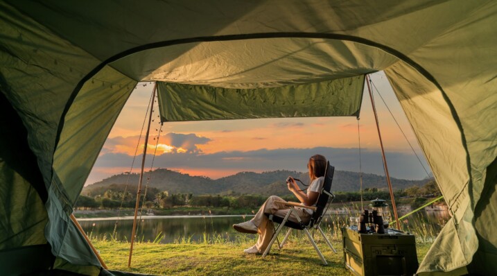 Asian woman travel and camping alone at natural park in Thailand. Recreation and journey outdoor activity lifestyle.
